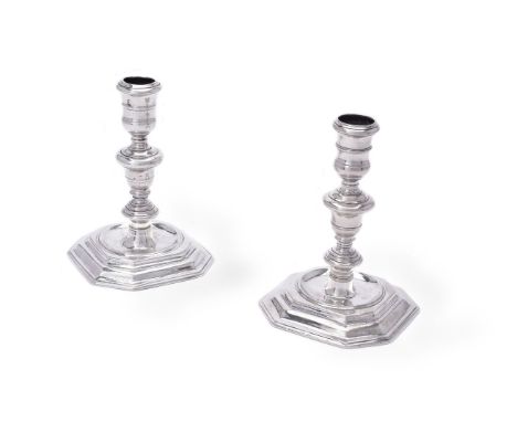 A matched pair of cast Britannia standard silver candlesticks, the first William III by Joseph Bird, maker's mark struck four