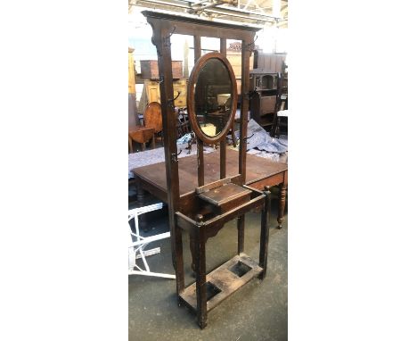 An oak hall stand, central oval mirror, with lidded compartment (af) and stick stand, 193cmH 