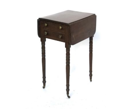 An early 19th century small mahogany pembroke table, two drawers, on ring turned tapering legs, with brass caps and casters, 