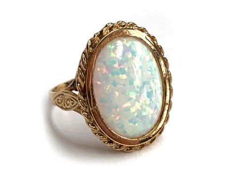 A 9ct gold ring set with a synthetic opal cabochon, size R 1/2, 5.4g 