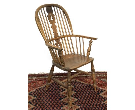 A 19th century ash and elm splatback windsor armchair, on ring turned legs and H stretcher, rear leg replaced, 63cmW 