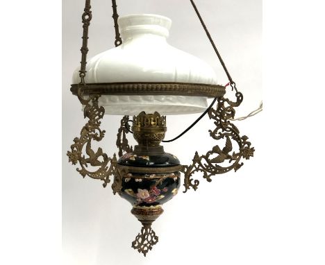 A hanging ceramic oil lamp with milk glass shade 