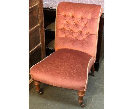 A Victorian button back slipper chair, on turned walnut legs and ceramic casters 