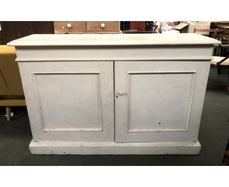 A Victorian painted pine cupboard, moulded top over two panelled doors, opening to a shelf, on plinth base, 138x36x91cmH 