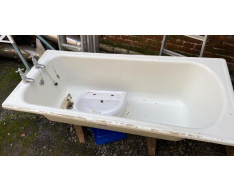 An enamel bath, together with a cloakroom basin 