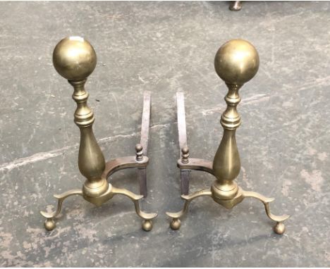 A pair of brass and iron fire dogs, 42cmH; together with a small three fold fire screen 