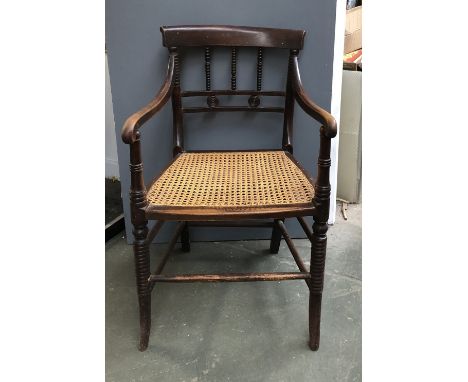 An unusual 19th century open armchair, with bobbin turned spindles and supports, caned seat, 50cmW 