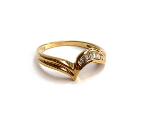 An 18ct gold ring with channel set baguette cut diamonds, size O 1/2, 2.7g 