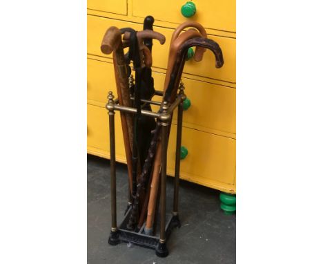 A brass and cast iron stick stand, 66cmH; together with a quantity of walking sticks and a shooting stick 