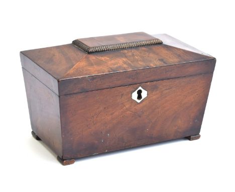 A Regency mahogany sarcophagus tea caddy, the lid with central gadrooned tablet 
