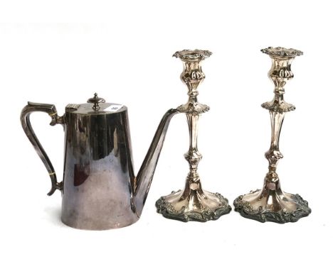 A pair of silver plated candlesticks, each 26.5cmH; together with a plated teapot 