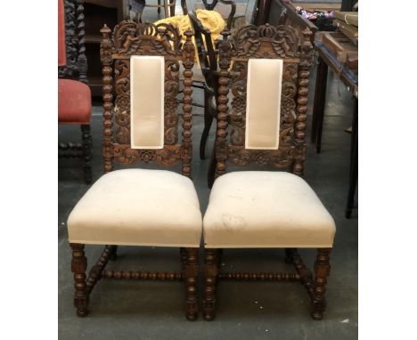A pair of carved oak side chairs, on block and bobbin turned supports 