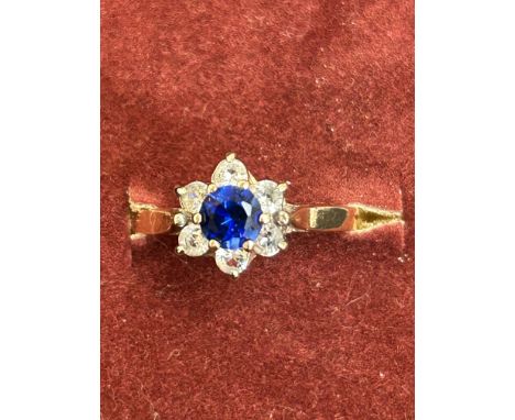 9ct Gold ring set with central sapphire surrounded by white sapphires Size M.5 