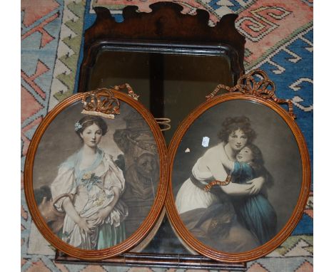A walnut fret carved wall mirror; together with a pair of portrait prints framed as ovals (3) 