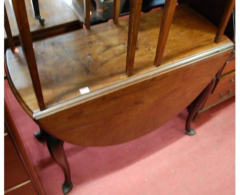 An early George III mahogany drop leaf dining table, having a gate leg action and raised on cabriole supports to pointed pad 