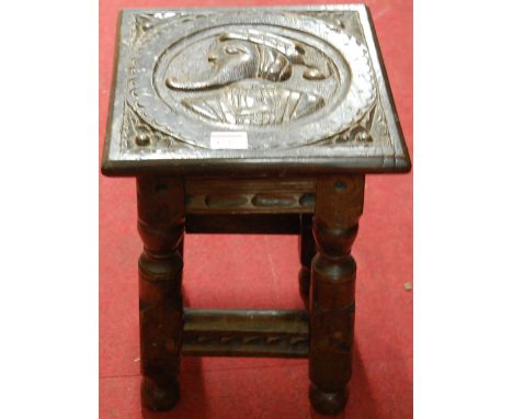 A Continental antique joined oak square section joint stool, low relief carved with bust portrait, w.27cm 