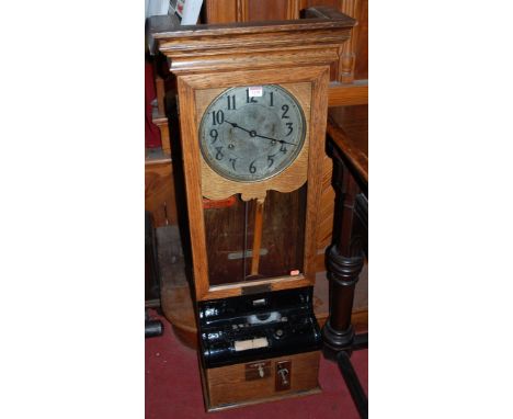 An early 20th century oak cased clocking-in and clocking-out clock, by the International Time Recording Company, 112 Strand, 