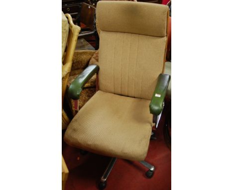 A 1960s plywood, chrome and upholstered swivel desk armchair, having gaslift action and raised on roller casters
