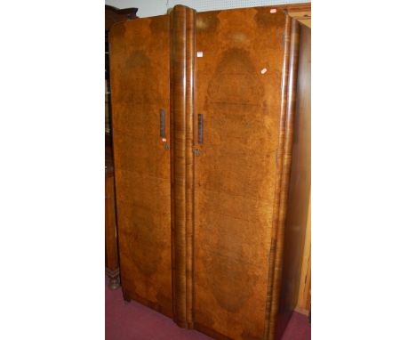 An Art Deco figured walnut and crossbanded double door wardrobe, w.115cm