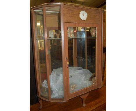 A 1950s laminate single door glazed clock display cabinet