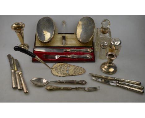 A quantity of sundry silver-mounted items, including a cased knife and fork, a .925 pastry slice with pierced and engraved de