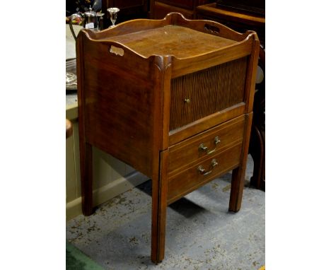 A 19th century mahogany tray-top commode with tambour door over a step drawer faced as two drawers