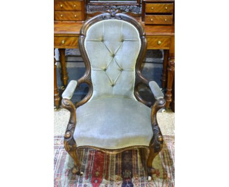 A Victorian walnut framed button-backed spoonback open armchair on ceramic castors