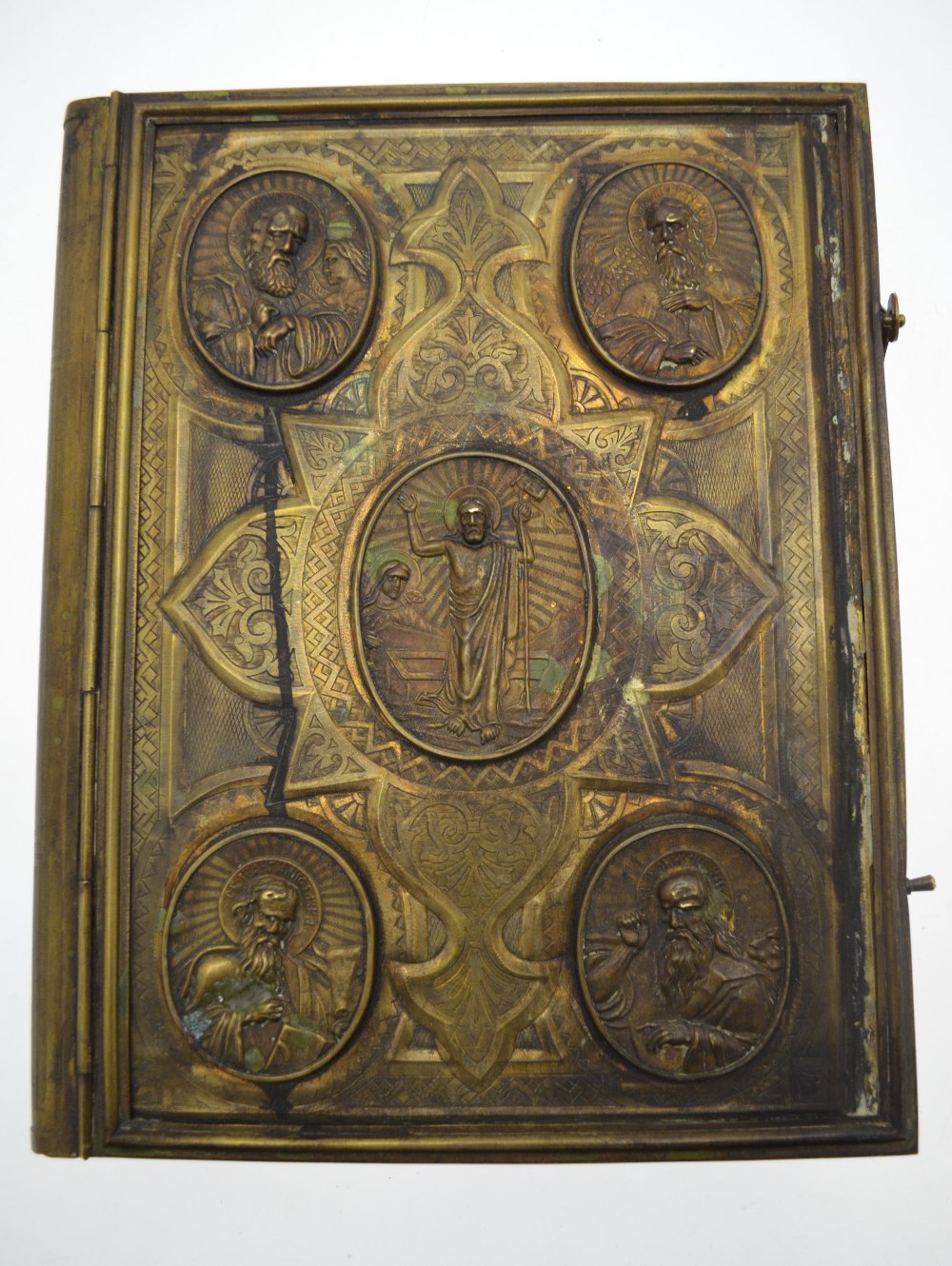 A 19th century Russian Orthodox Bible, the heavy brass cover richly ...