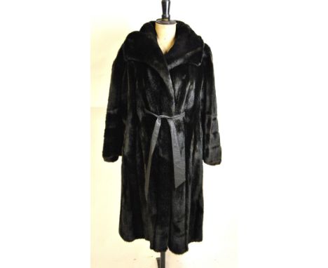 A black faux fur full-length 'Tissavel' lady's coat with wide collar and flared sleeves with tie-belt fastening, retailed by 