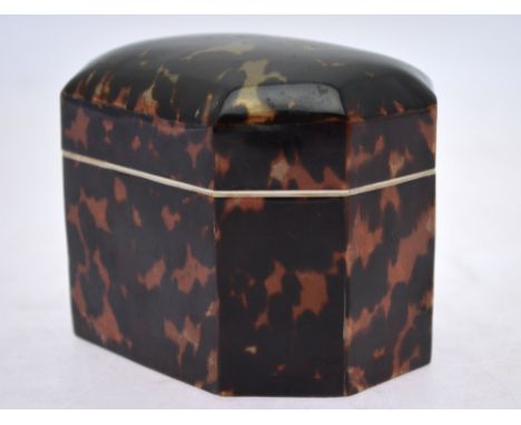 A tortoiseshell tea caddy of elongated octagonal form with bone rim and inner cover, 11 cm wide, late 20th century Condition 