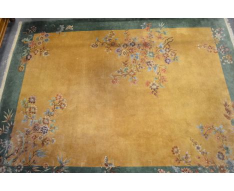 A large Chinese carpet, the golden camel ground, trailing peony to green borders circa. 1950s, 384 x 302 cm