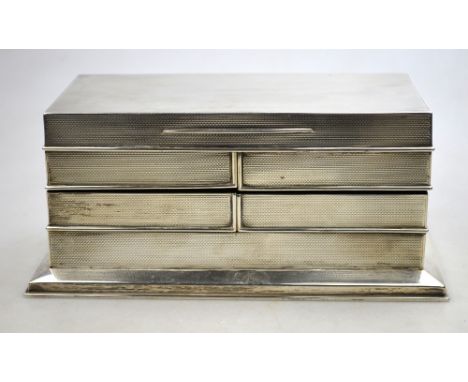 An unusual engine-turned silver cigarette box with four swing-cut compartments and hinged top (no maker's mark), London 1913,