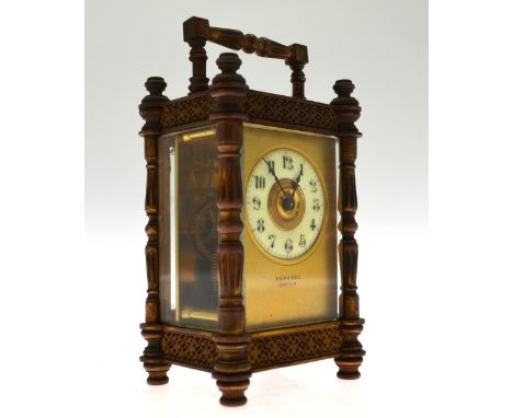 Edwards, Exeter, a lacquered brass gothic styled carriage clock with white ceramic dial within a gilt mount, 15 cm high overa