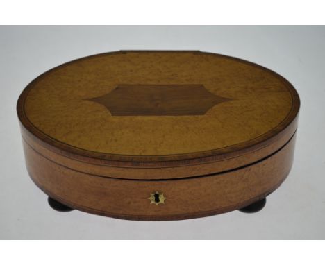 A 19th century oval maple and rosewood crossbanded trinket box with compartmented interior enclosed by cover with marquetry i