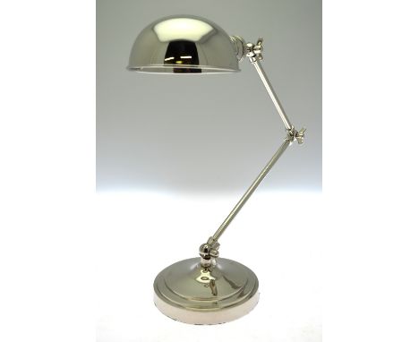 A nickel-plated adjustable desk lamp with domed shade
