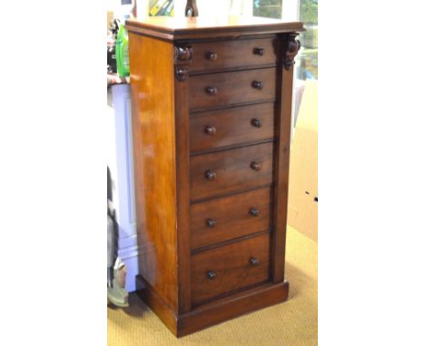A Victorian mahogany Wellington chest of six drawers having turned pulls, raised on a plinth base Condition Report good sound