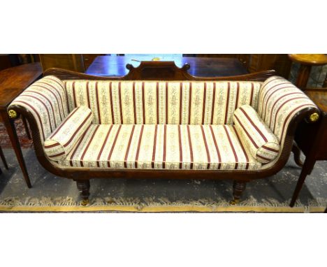 A Regency brass inlaid mahogany scroll end sofa raised on turned legs to brass castors, 185 cm wide x 63 cm deep x 87 cm high