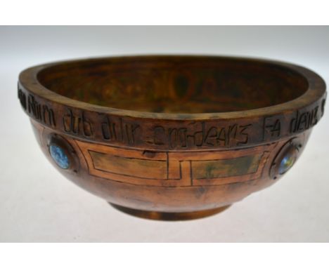 An Irish Arts & Crafts style turned wood bowl, set with enamel bosses in rivetted copper surrounds, Gaelic inscription to rim