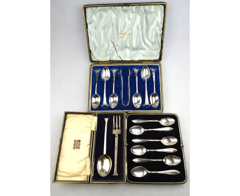 An Edwardian cased set of six teaspoons and tongs with scroll finials, Walker & Hall, Sheffield 1903, to/w a cased set of six