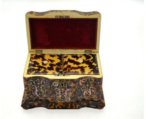 A Victorian tortoiseshell tea caddy of serpentine-front form, richly inlaid with scrolling foliate mother-of-pearl and with i