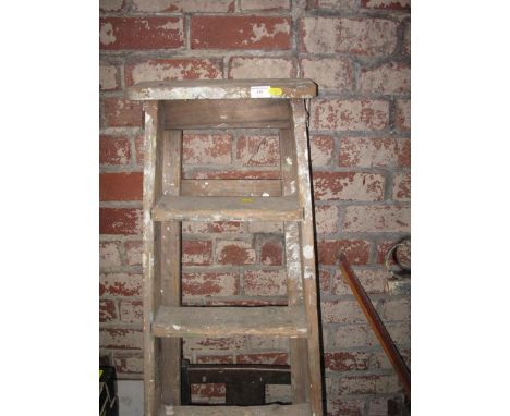 pair of wood step ladders and a chair