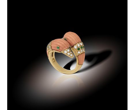 A COLLECTIBLE CORAL, EMERALD AND DIAMOND RING, BY VAN CLEEF & ARPELS, CIRCA 1970 Of cross-over design, modelled as two stylis