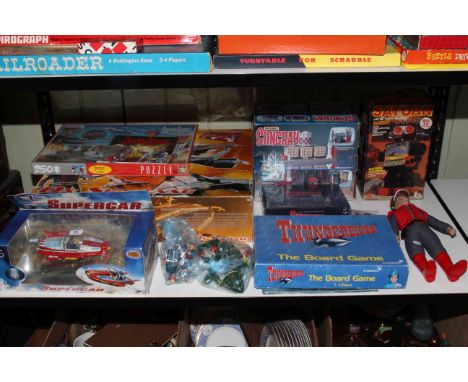 Shelf of toys, dolls and games including Supercar, Captain Scarlet, Stingray, Thunderbirds and Saturn Robot.