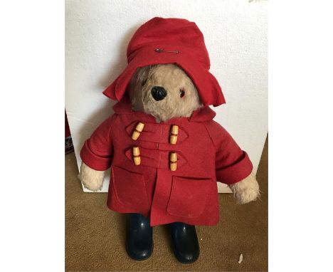 A Gabrielle Designs Paddington Bear soft toy, in red hat, red duffel coat, blue Dunlop Wellington boots, and pyjamas. 46cm hi