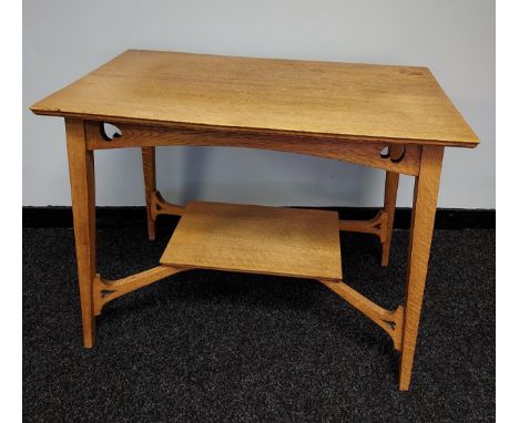 An Arts and crafts light oak two tier window table. 