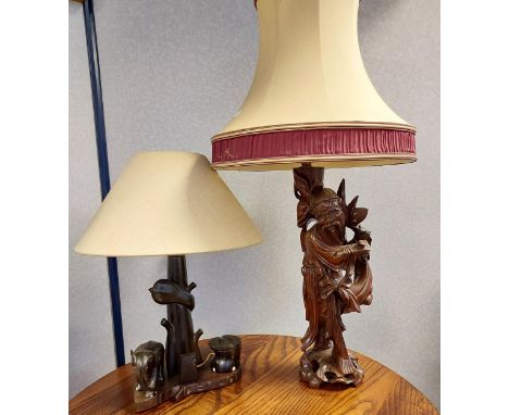 A Japanese hand carved wooden figure table lamp together with an African carved elephant table lamp 