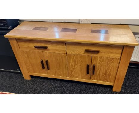 A Solid light oak sideboard, Consists of two drawers and four doors. [82x148x46cm] 