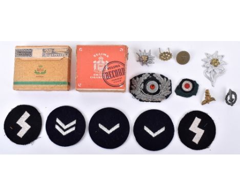 WW2 German Badges and Cigarettes: Cloth and metal HJ, army badges and two boxes of period cigarettes. (15 items) 