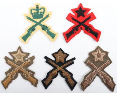 5x British Army Marksman Proficiency Badges, four being examples of crossed rifles with star above and one with Elizabeth II 