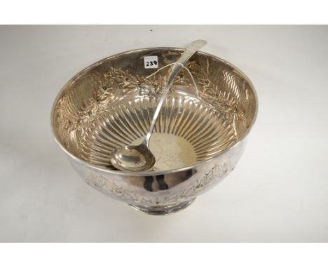 A silver-plated punch bowl with embossed decoration; and a silver-plated ladle with engraved decoration. (2)